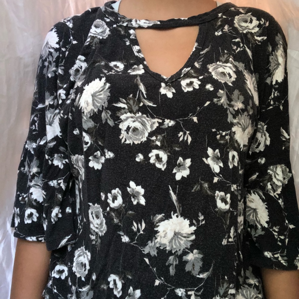 Floral shirt with a opening in the front and back.